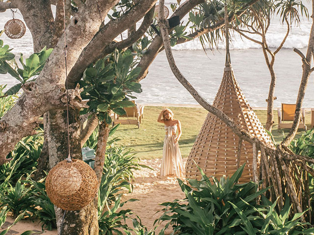 Lady in long dress by the beach at The Fortress Resort & Spa