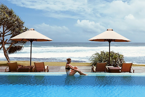 A lady relaxing at the infinity pool at The Fprtress one of the best hotels in Koggala, Sri Lanka